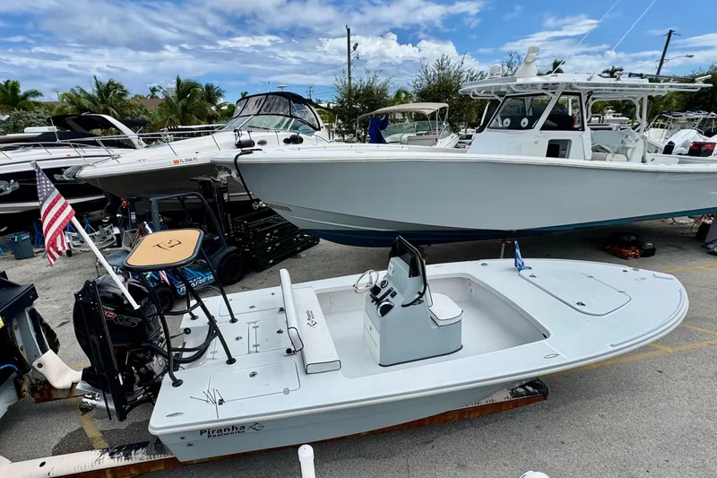 Slide: The Image of 2026 Piranha B2000 boat in marina, surrounded by other vessels, under a partly cloudy sky. - 4