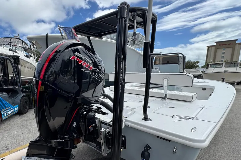 Slide: The Image of 2026 Piranha B2000 boat with Mercury Pro XS engine, docked under a cloudy sky. - 7