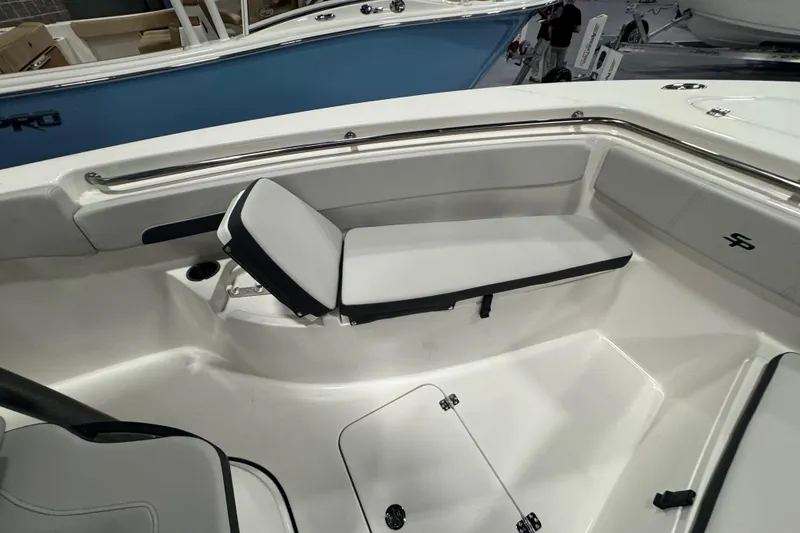 Slide: The Image of 2026 Sea Pro 222 Center Console boat interior with cushioned seating and stainless steel railings. - 23