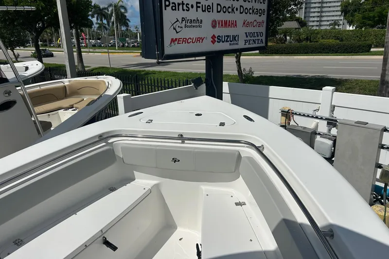 Slide: The Image of 2026 Sea Pro 222 Center Console boat displayed at a dealership with service signage. - 26