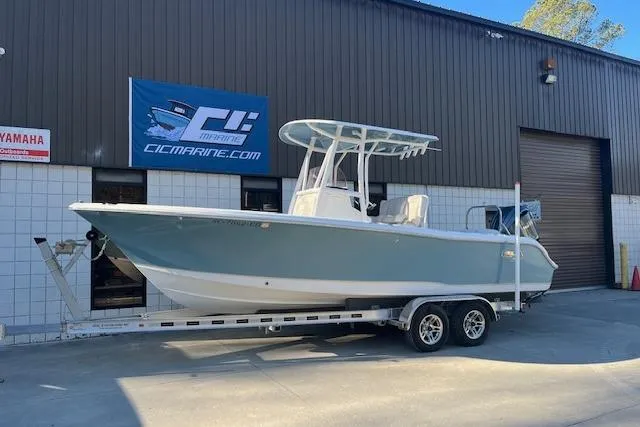 The Image of 2023 Sea Hunt Ultra 234 boat on trailer outside marine dealership. - 1