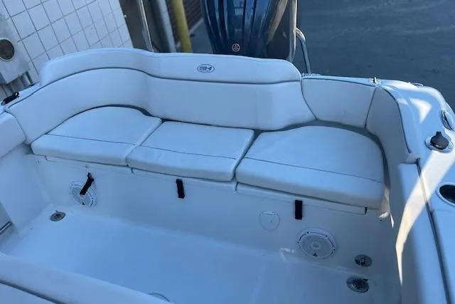Slide: The Image of 2023 Sea Hunt Ultra 234 boat with white cushioned seating and sleek design. - 11