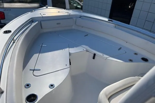Slide: The Image of 2023 Sea Hunt Ultra 234 boat interior with sleek white seating and storage compartments. - 13