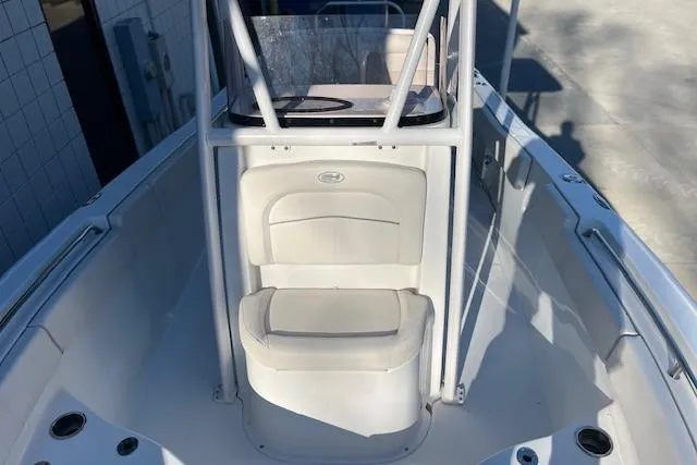 Slide: The Image of 2023 Sea Hunt Ultra 234 boat interior with seating and console. - 15