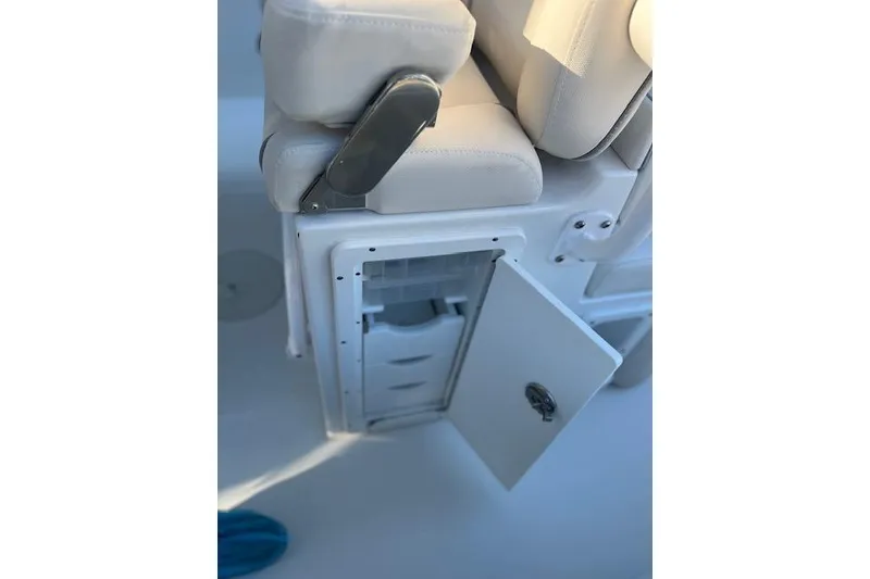Slide: The Image of 2023 Sea Hunt Ultra 234 boat seat with open storage compartment. - 18