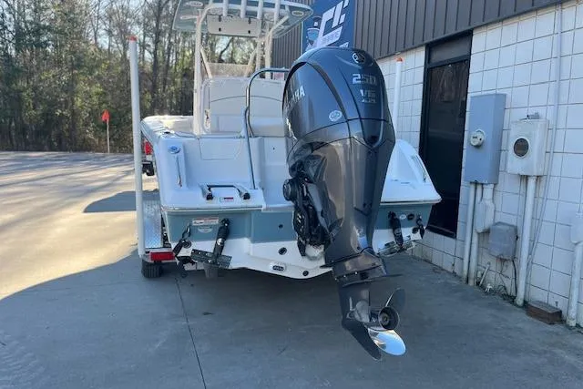 Slide: The Image of 2023 Sea Hunt Ultra 234 boat with Yamaha 250 V6 engine, parked outdoors. - 3