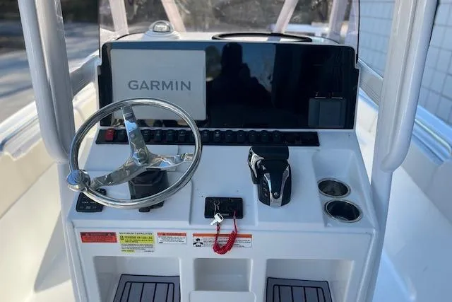 Slide: The Image of 2023 Sea Hunt Ultra 234 boat console with Garmin navigation system and steering wheel. - 4