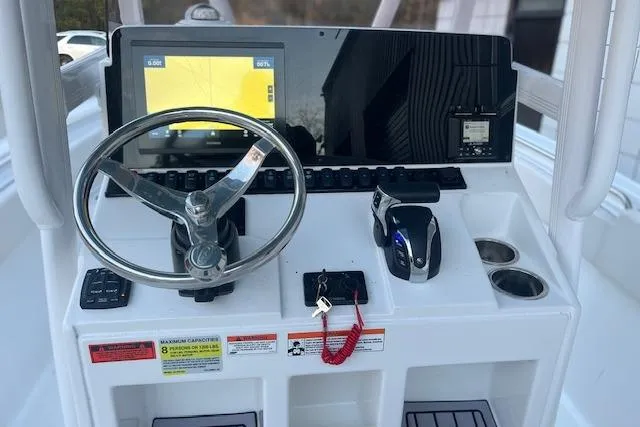 Slide: The Image of 2023 Sea Hunt Ultra 234 boat dashboard with steering wheel and navigation display. - 5