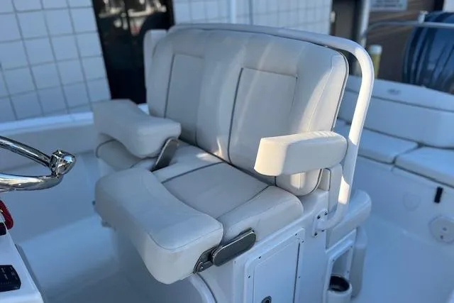 Slide: The Image of 2023 Sea Hunt Ultra 234 boat seating with white cushioned armrests. - 7