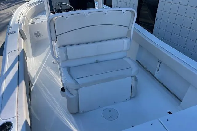 Slide: The Image of 2023 Sea Hunt Ultra 234 boat interior with white seating and spacious deck. - 8