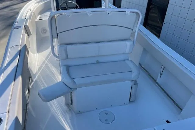 Slide: The Image of 2023 Sea Hunt Ultra 234 boat interior with white seating and sleek design. - 9