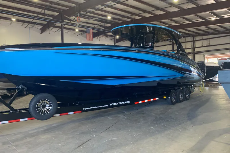 Slide: The Image of 2023 Mystic Powerboats M4200 in a warehouse, displayed on a trailer. - 10