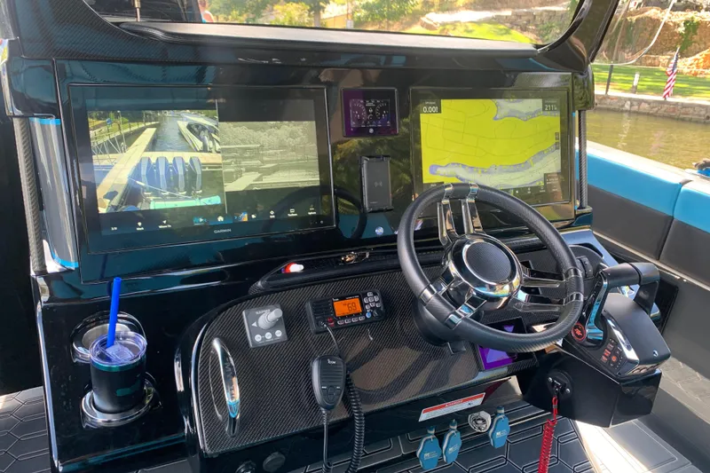 Slide: The Image of Cockpit of 2023 Mystic Powerboats M4200 with advanced navigation displays and controls. - 3
