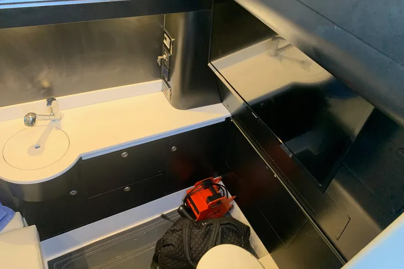 Slide: The Image of Interior of 2023 Mystic Powerboats M4200, featuring sleek bathroom design with modern fixtures. - 9