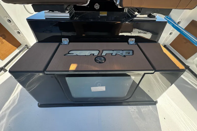 Slide: The Image of 2026 Sea Pro 245FLX Sandbar boat interior with branded storage compartment. - 22