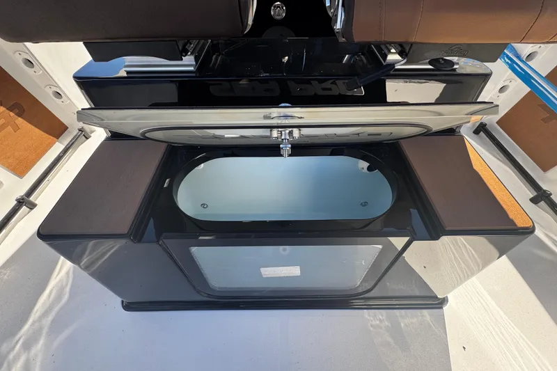 Slide: The Image of 2026 Sea Pro 245FLX Sandbar boat interior with open storage compartment. - 23