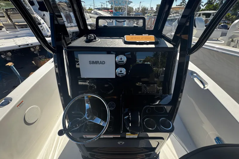 Slide: The Image of 2026 Sea Pro 245FLX Sandbar boat dashboard with Simrad navigation system and steering wheel. - 24