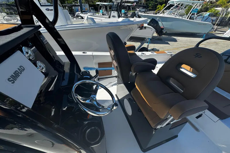 Slide: The Image of 2026 Sea Pro 245FLX Sandbar boat interior with steering wheel and seating. - 25