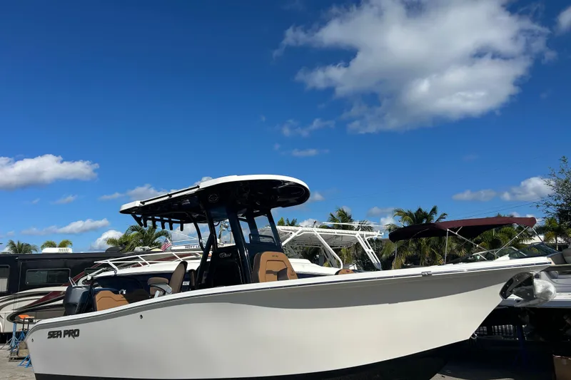 Slide: The Image of 2026 Sea Pro 245FLX Sandbar boat under clear blue sky with palm trees. - 3