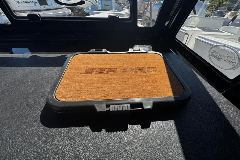 Slide: The Image of 2026 Sea Pro 245FLX Sandbar boat interior with branded wooden panel. - 35