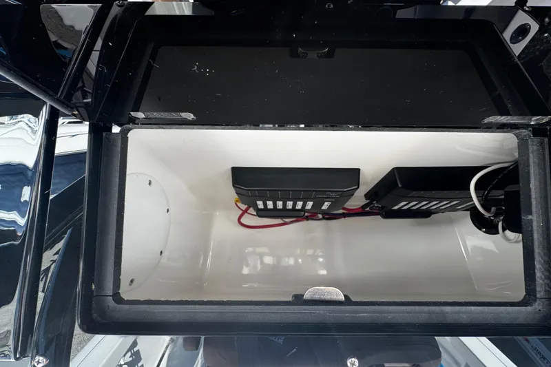 Slide: The Image of Storage compartment of 2026 Sea Pro 245FLX Sandbar boat with electrical components. - 37