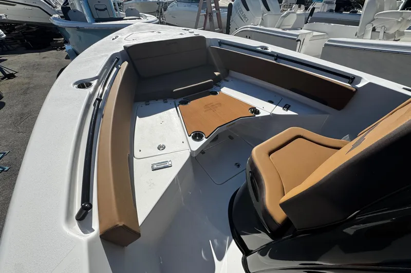 Slide: The Image of 2026 Sea Pro 245FLX Sandbar boat interior with brown seating and white deck. - 41