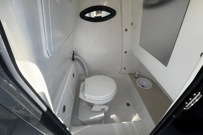 Slide: The Image of Interior of 2026 Sea Pro 245FLX Sandbar boat bathroom with toilet and sink. - 49