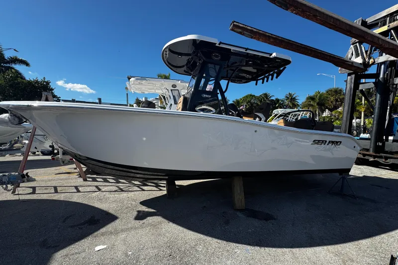 Slide: The Image of 2026 Sea Pro 245FLX Sandbar boat on display under clear blue sky. - 5