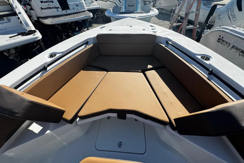 Slide: The Image of 2026 Sea Pro 245FLX Sandbar boat interior with tan seating and cup holders. - 50