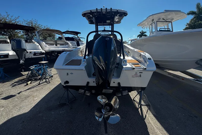 Slide: The Image of 2026 Sea Pro 245FLX Sandbar boat with powerful outboard motor, parked outdoors. - 7