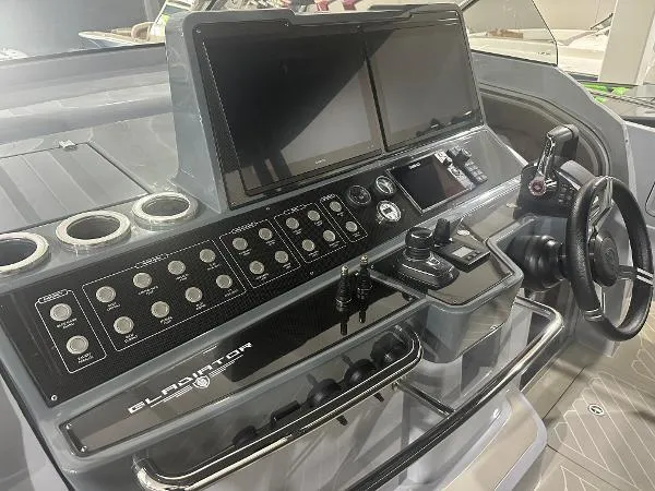 Slide: The Image of Control panel of 2023 Canados 435 Gladiator boat with dual screens and navigation controls. - 10