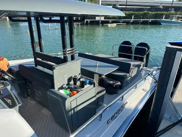 Slide: The Image of 2023 Canados 435 Gladiator boat docked, featuring sleek design and modern amenities. - 6
