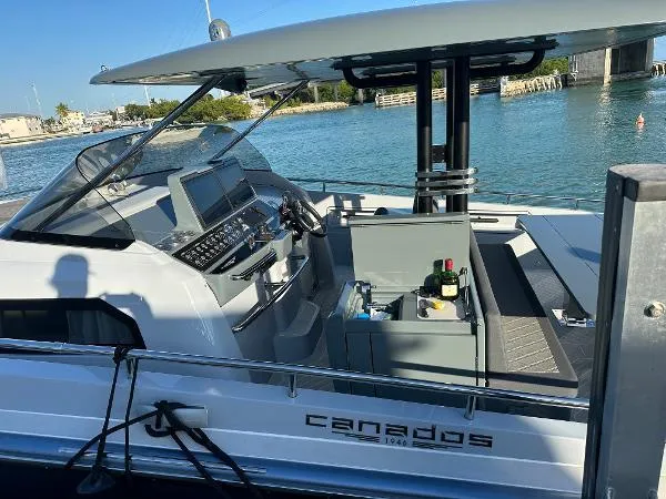 Slide: The Image of 2023 Canados 435 Gladiator yacht docked, featuring sleek design and modern cockpit controls. - 8