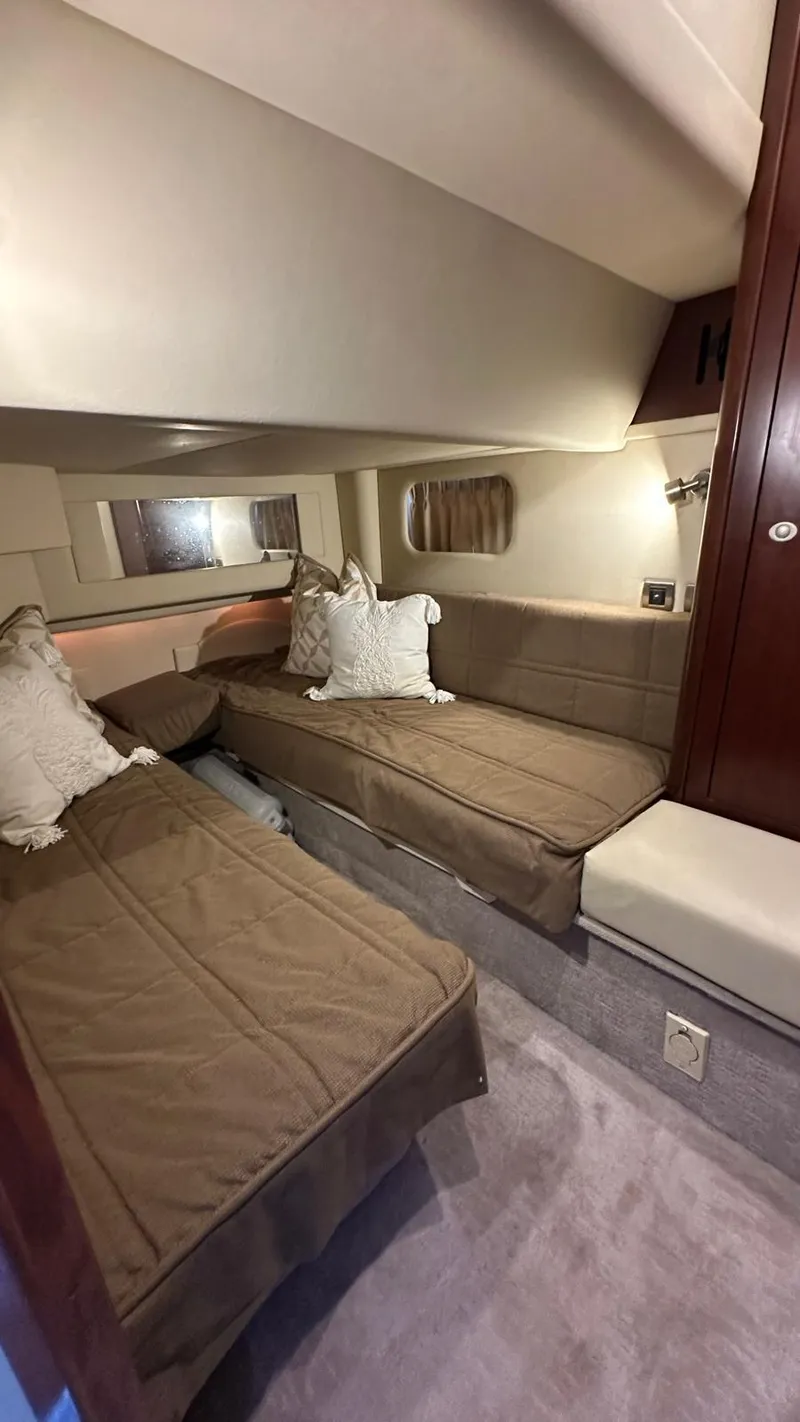 Slide: The Image of 2006 Sea Ray 44 Sedan Bridge cabin with twin beds and cozy decor. - 17