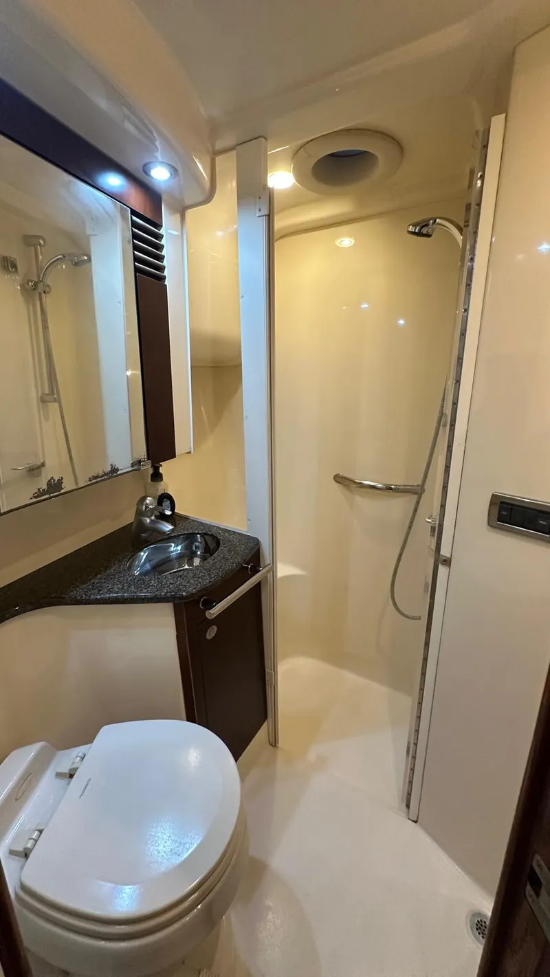 Slide: The Image of 2006 Sea Ray 44 Sedan Bridge bathroom with shower, sink, and toilet. - 20