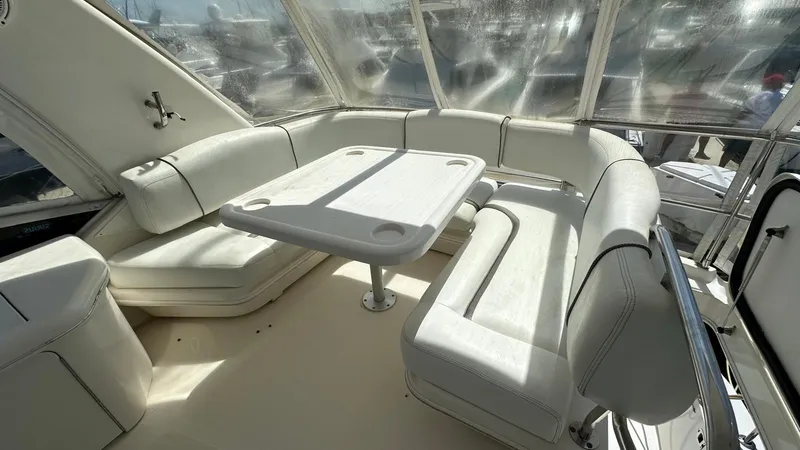 Slide: The Image of 2006 Sea Ray 44 Sedan Bridge interior with white seating and table. - 22