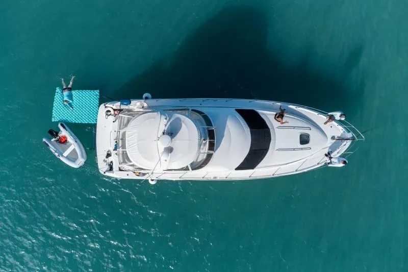 Slide: The Image of Aerial view of 2006 Sea Ray 44 Sedan Bridge yacht on turquoise water. - 4