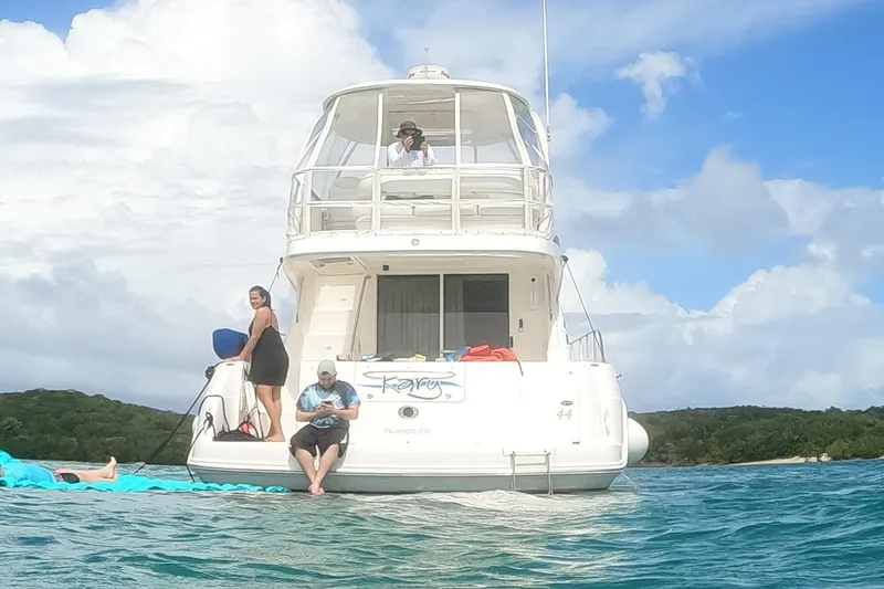 Slide: The Image of 2006 Sea Ray 44 Sedan Bridge yacht with people enjoying a sunny day on the water. - 5