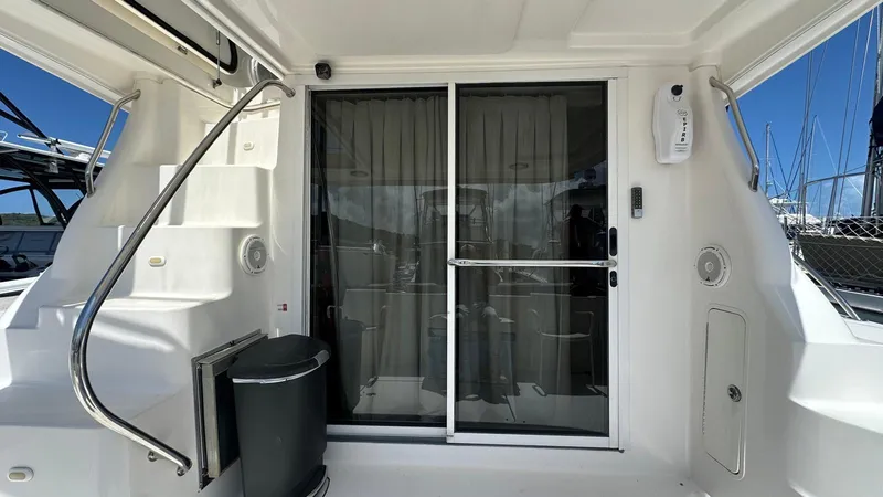 Slide: The Image of 2006 Sea Ray 44 Sedan Bridge yacht with sliding glass door and staircase. - 9