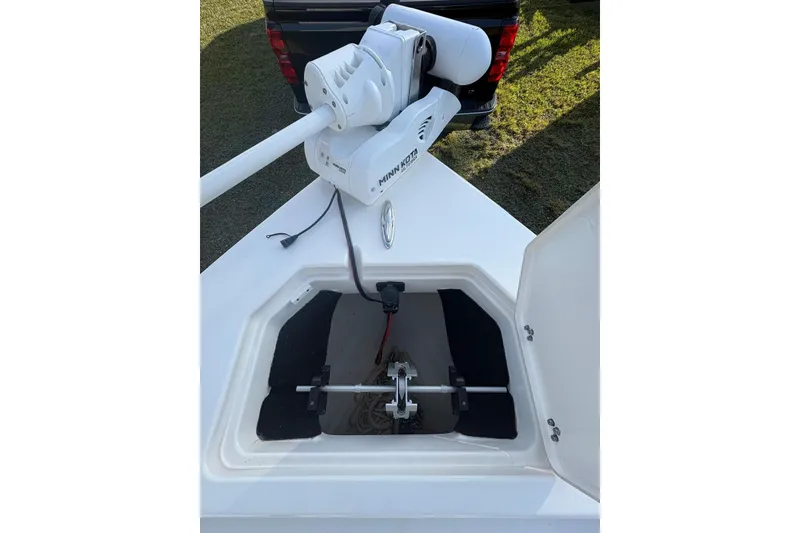 Slide: The Image of 2022 Pathfinder 2400 TRS boat with Minn Kota trolling motor and open storage compartment. - 12