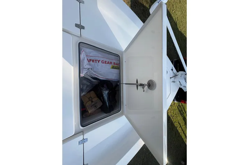 Slide: The Image of Open storage compartment on 2022 Pathfinder 2400 TRS boat with safety gear bag. - 15