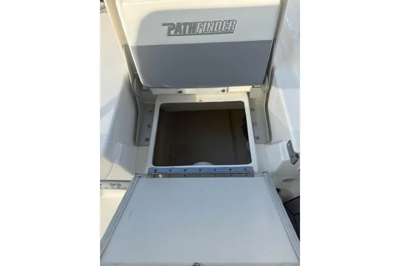 Slide: The Image of 2022 Pathfinder 2400 TRS boat storage compartment with open lid. - 18