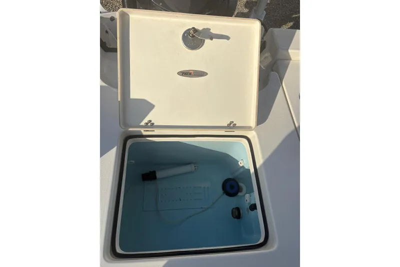 Slide: The Image of Open storage compartment on 2022 Pathfinder 2400 TRS boat, featuring interior components. - 20