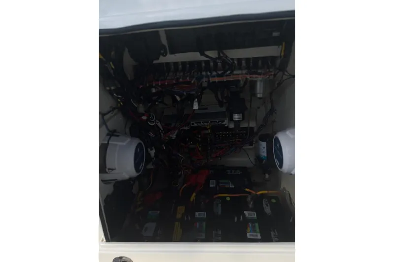 Slide: The Image of Electrical compartment of a 2022 Pathfinder 2400 TRS boat with wiring and components. - 29