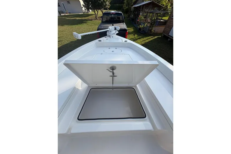 Slide: The Image of 2022 Pathfinder 2400 TRS boat with open storage compartment and trolling motor. - 32