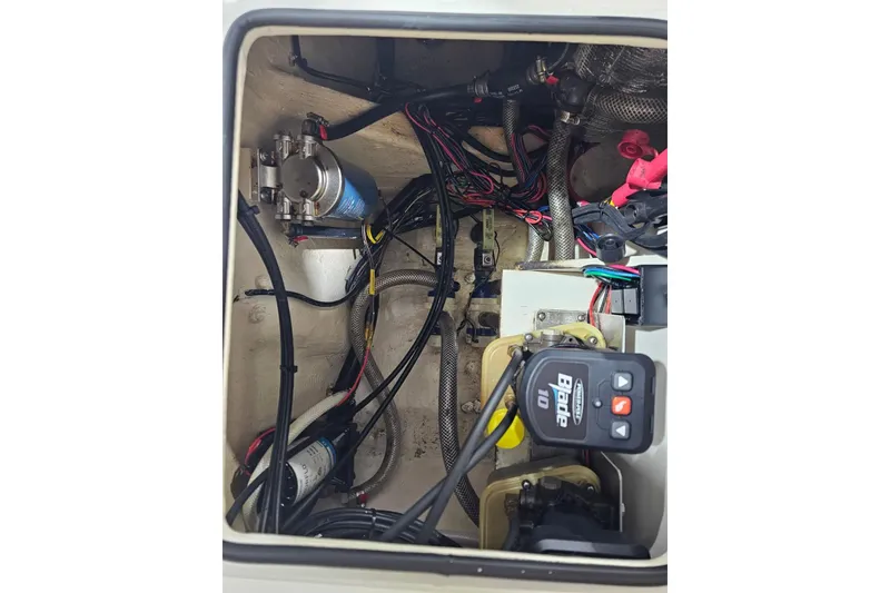 Slide: The Image of 2022 Pathfinder 2400 TRS boat wiring and components in compartment view. - 33