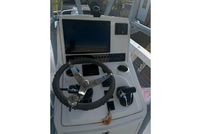 Slide: The Image of 2022 Pathfinder 2400 TRS boat console with steering wheel and navigation display. - 4