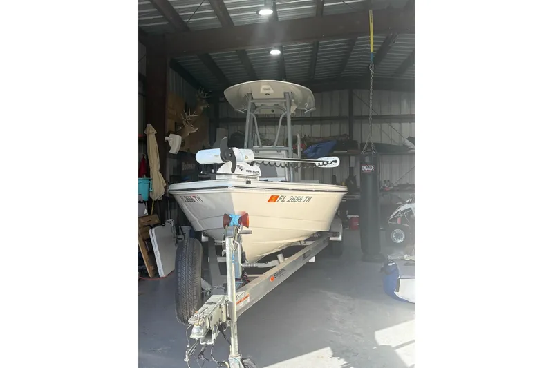 Slide: The Image of 2022 Pathfinder 2400 TRS boat in a garage, on a trailer. - 5