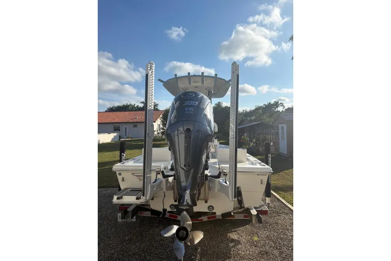 Slide: The Image of 2022 Pathfinder 2400 TRS boat with powerful V6 engine, parked outdoors under blue sky. - 8