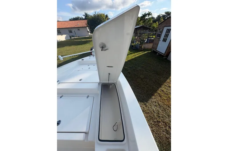 Slide: The Image of Open storage compartment on 2022 Pathfinder 2400 TRS boat, outdoor setting. - 9